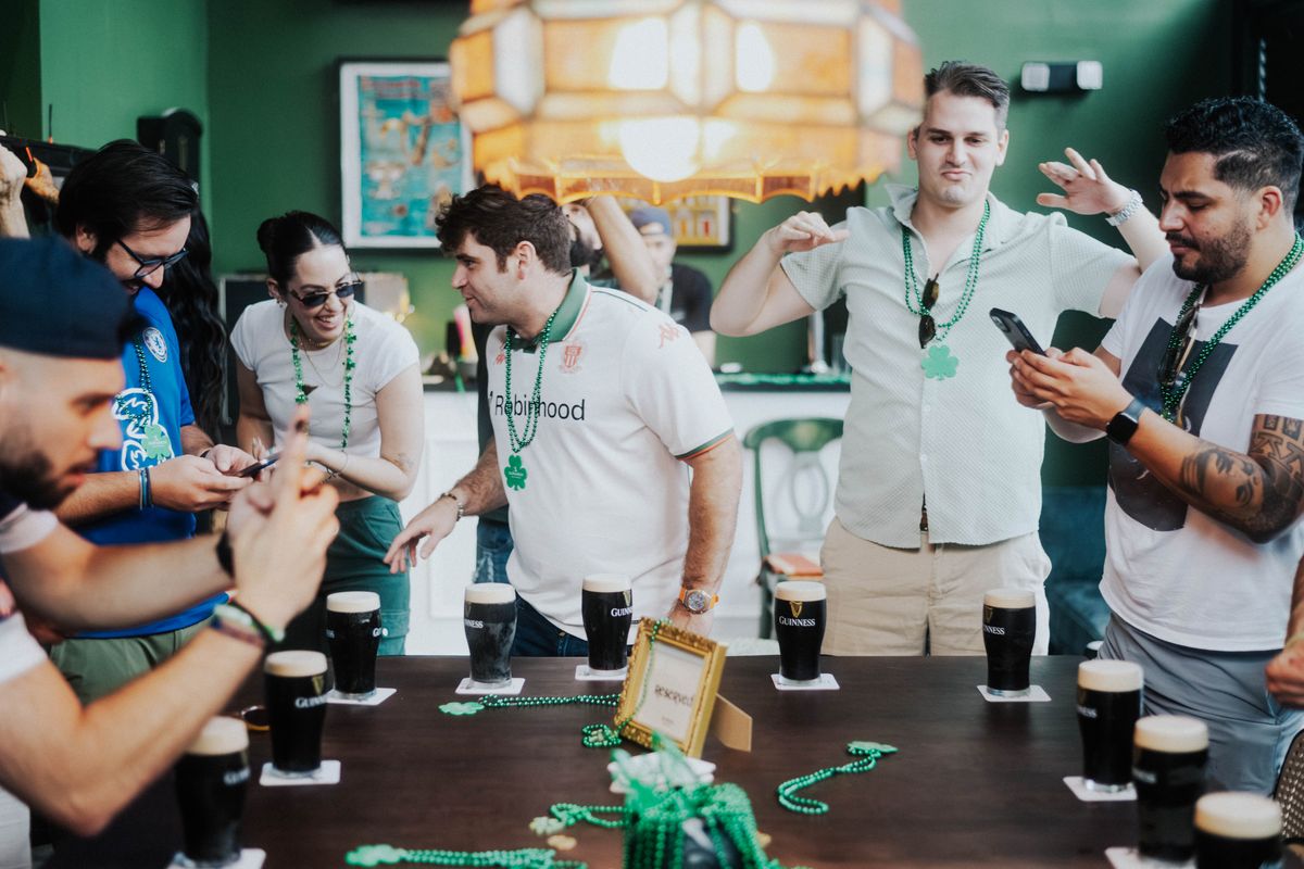Split the G contestants lined up with pints of Guinness at The Leinster Miami