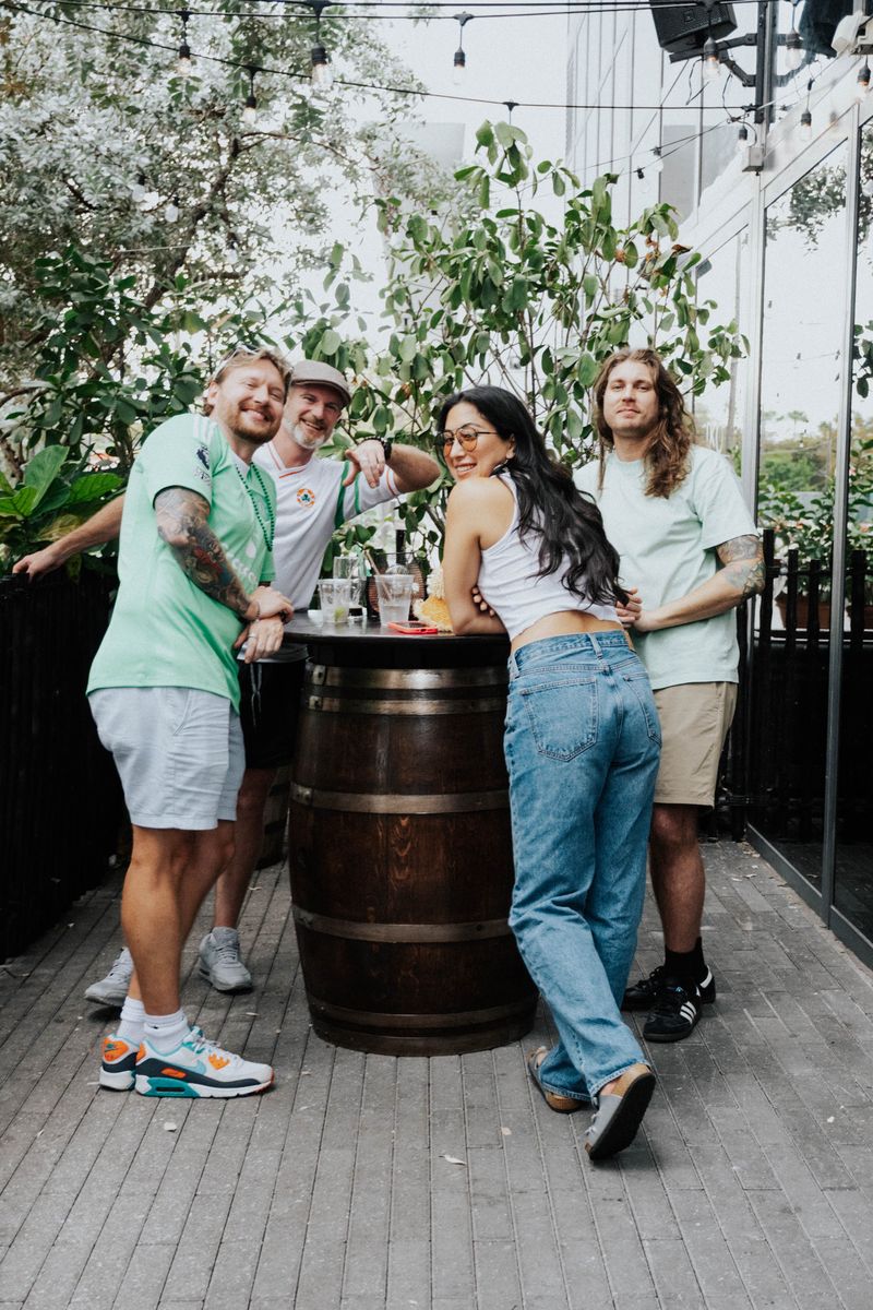 Friends at barrel table on the patio during St. Patrick's Day at The Leinster