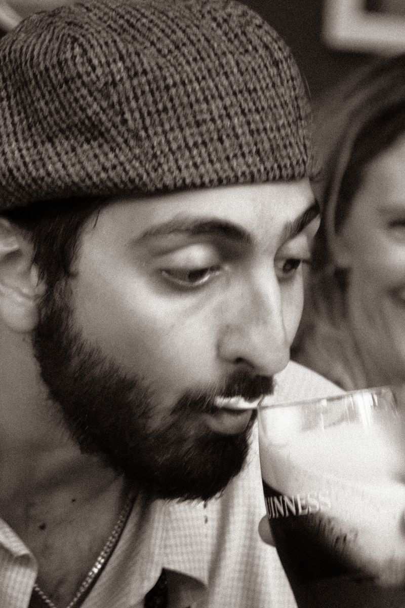 Close-up of competitor sipping Guinness during Split the G competition in Miami